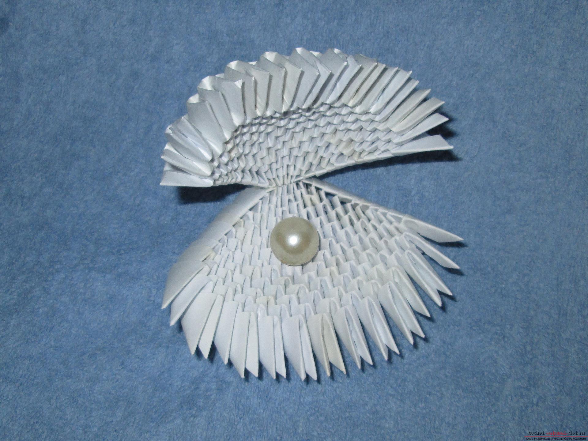 Ракушка для упаковки небольшого подарка собрана в технике модульное оригами в нашем мастер-классе с описанием и фото.. Фото №1